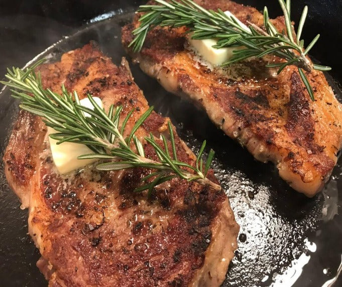 Two ribeye steaks braised and pan fried