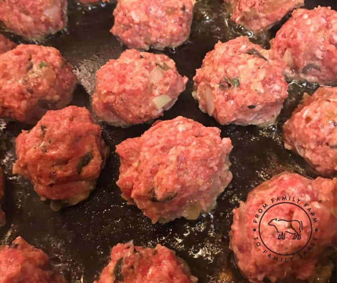 meatballs frying in a pan